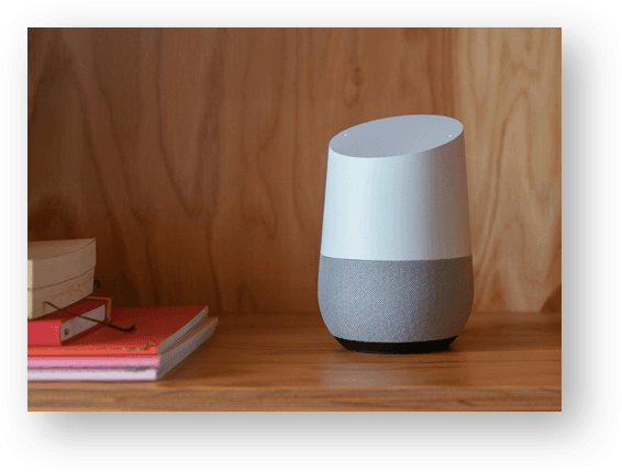 google home device laying on shelf